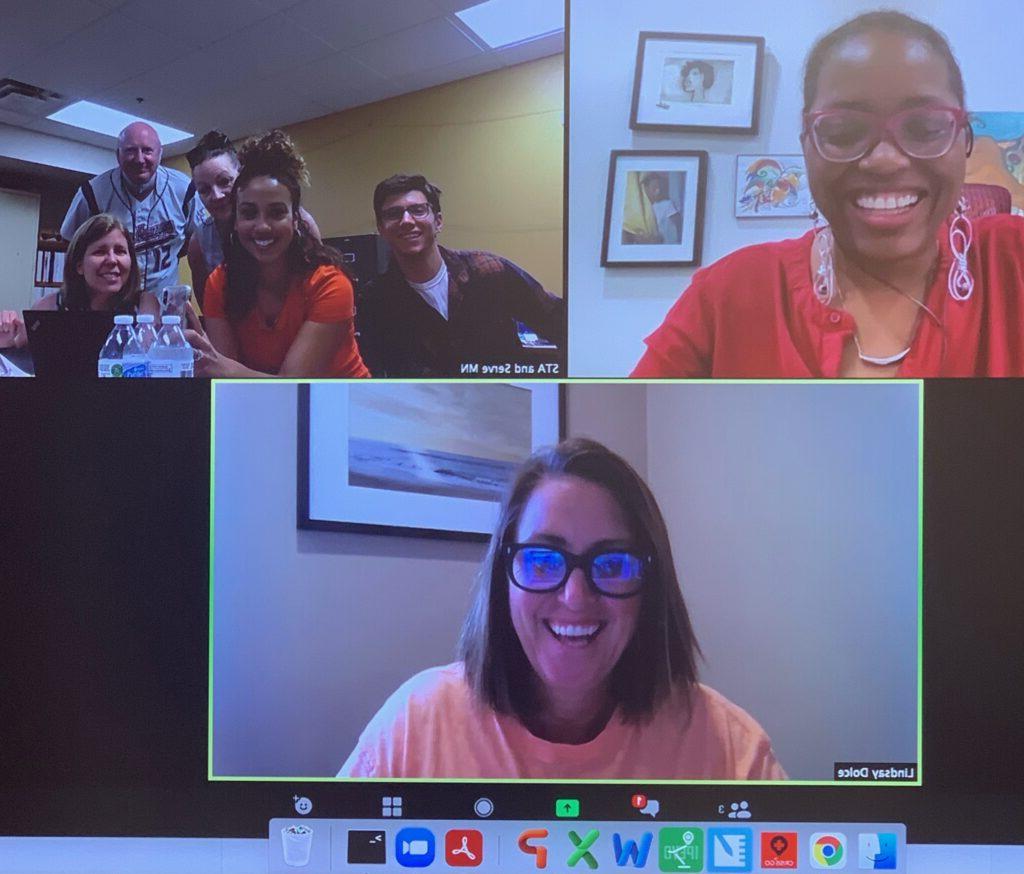 Screenshot of video call with three screens. Two have one smiling person each. The third has a group of people.